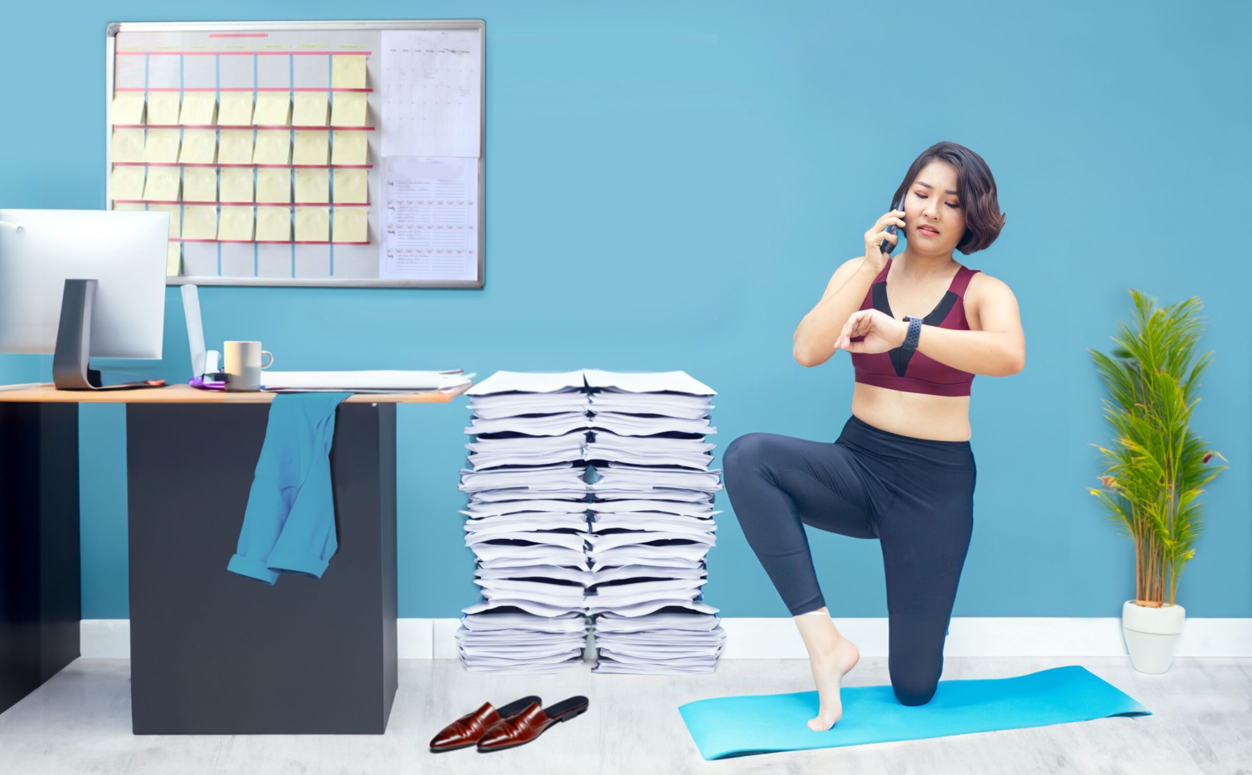 Asian woman doing yoga at the office as part of her daily routine