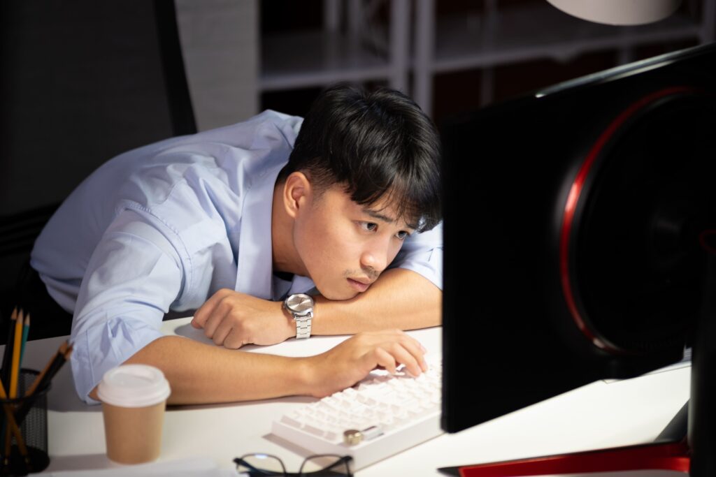 Tired female doctor staring at her screen while working at night