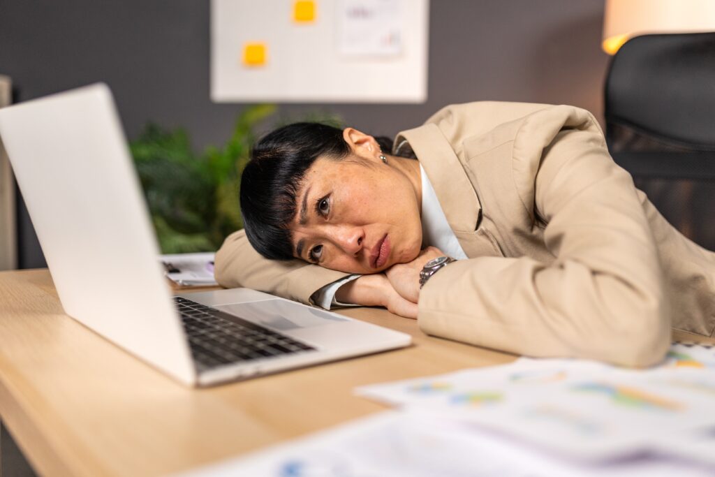 Tired female doctor staring at her screen while working at night